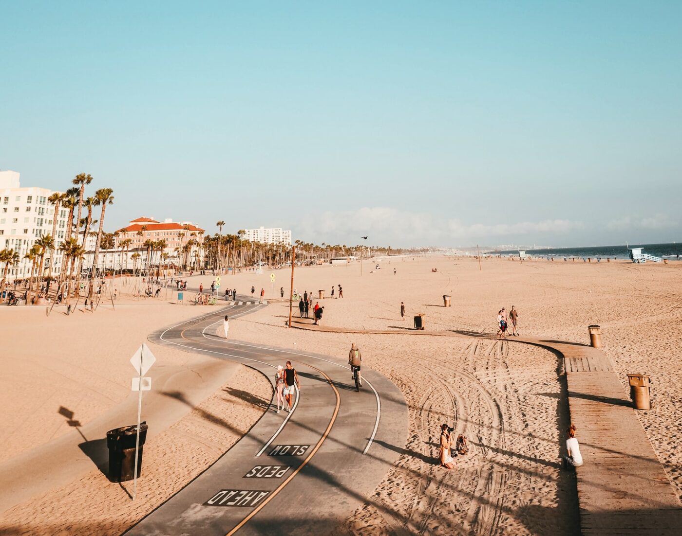 people on road and sand