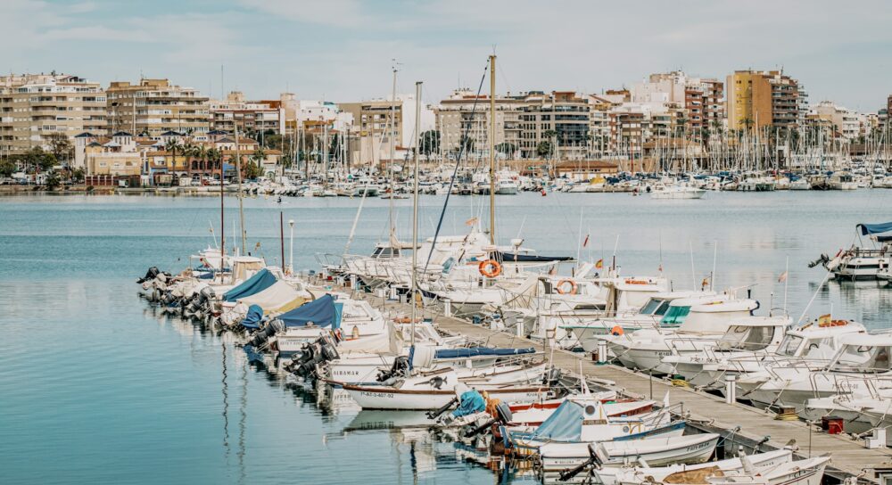 white and blue boats on dock during daytime