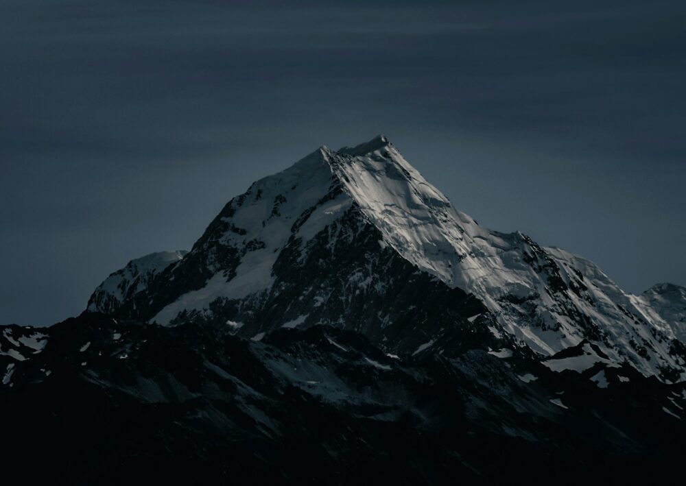 snow covered mountain during nighttime