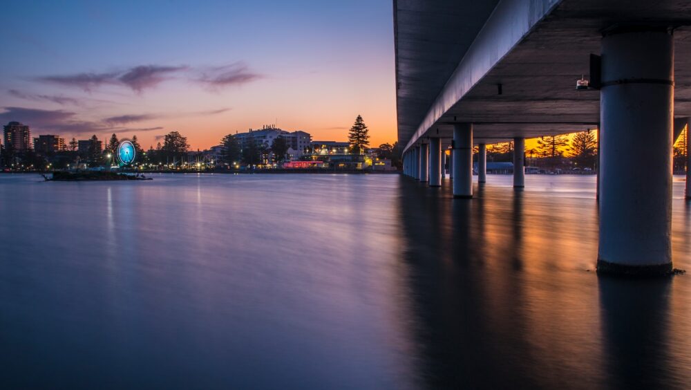 brown wooden dock on body of water during night time