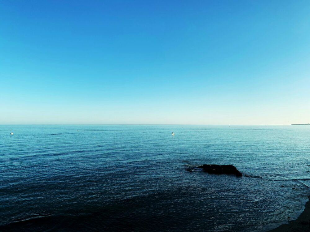 blue sea under blue sky during daytime