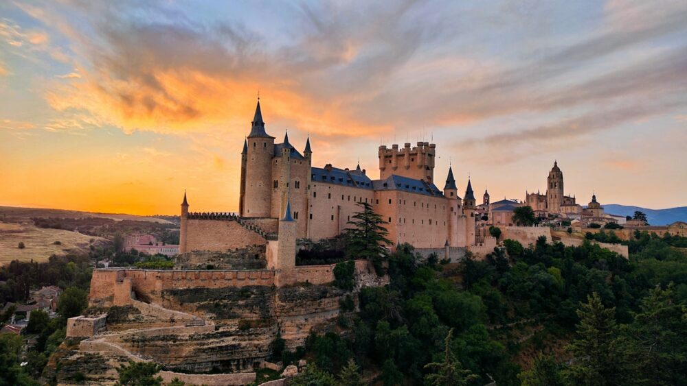 a castle sits on top of a cliff