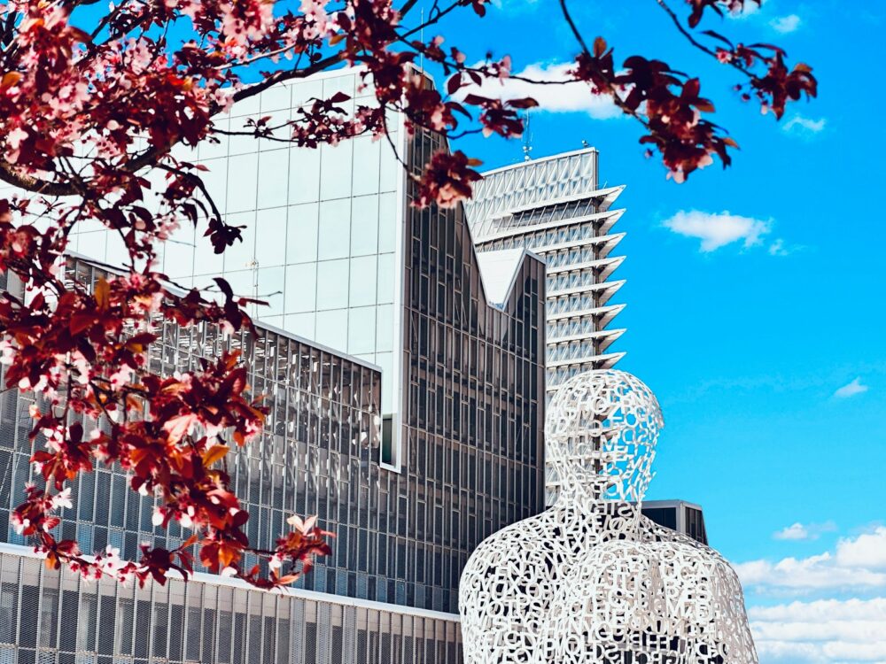 a tall building with a sculpture in front of it