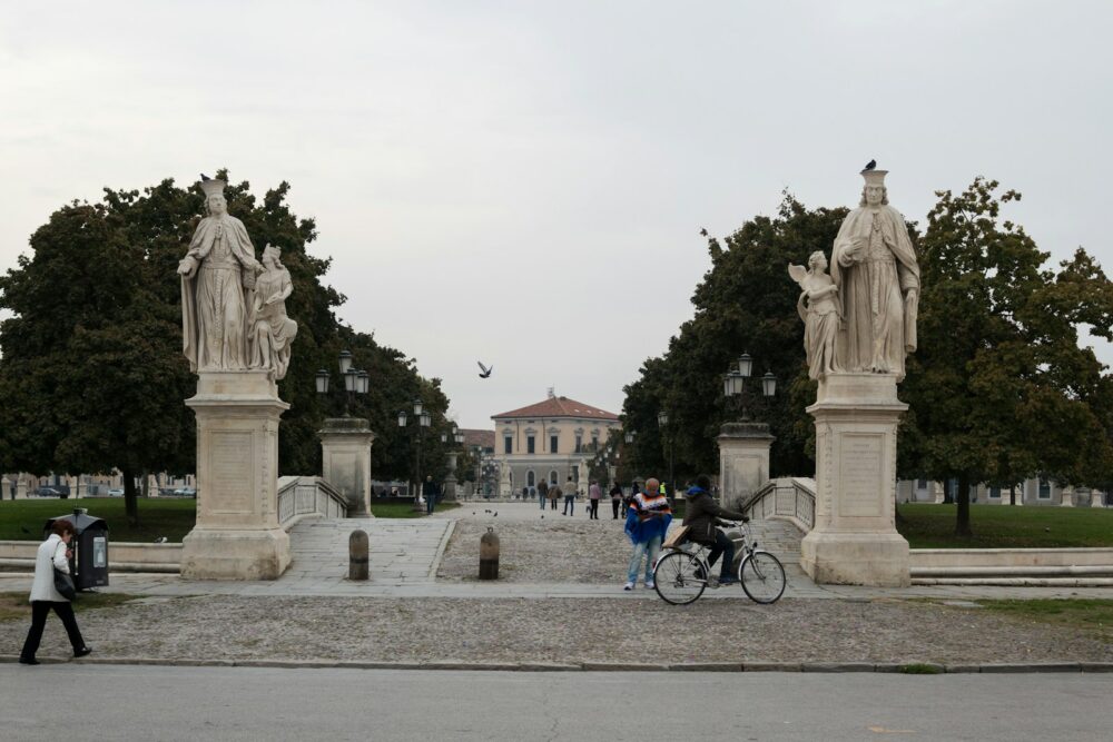 a group of people walking around a statue