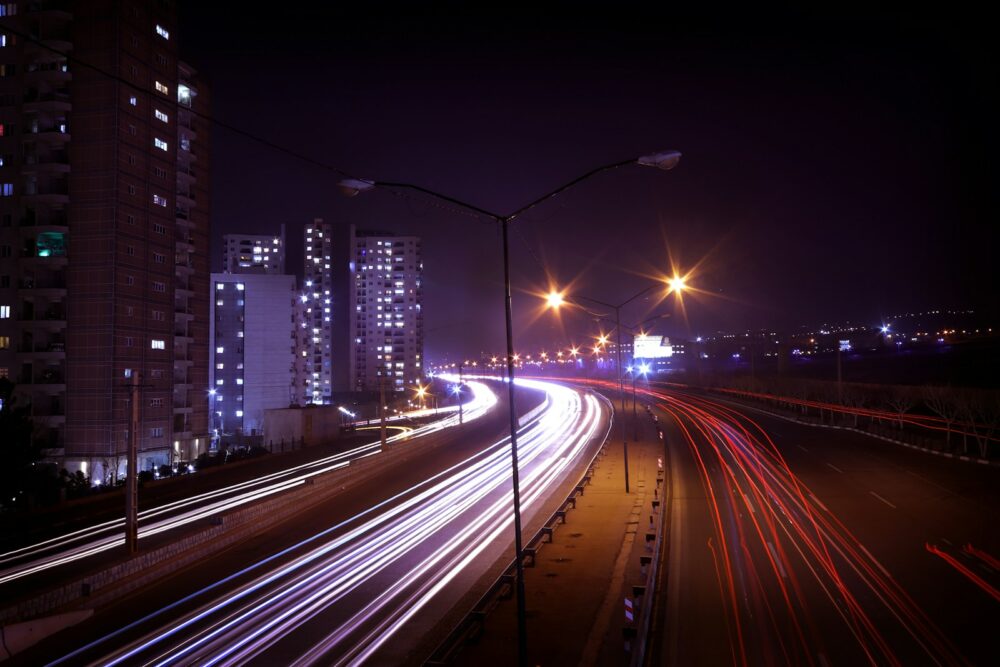 a city street filled with lots of traffic at night