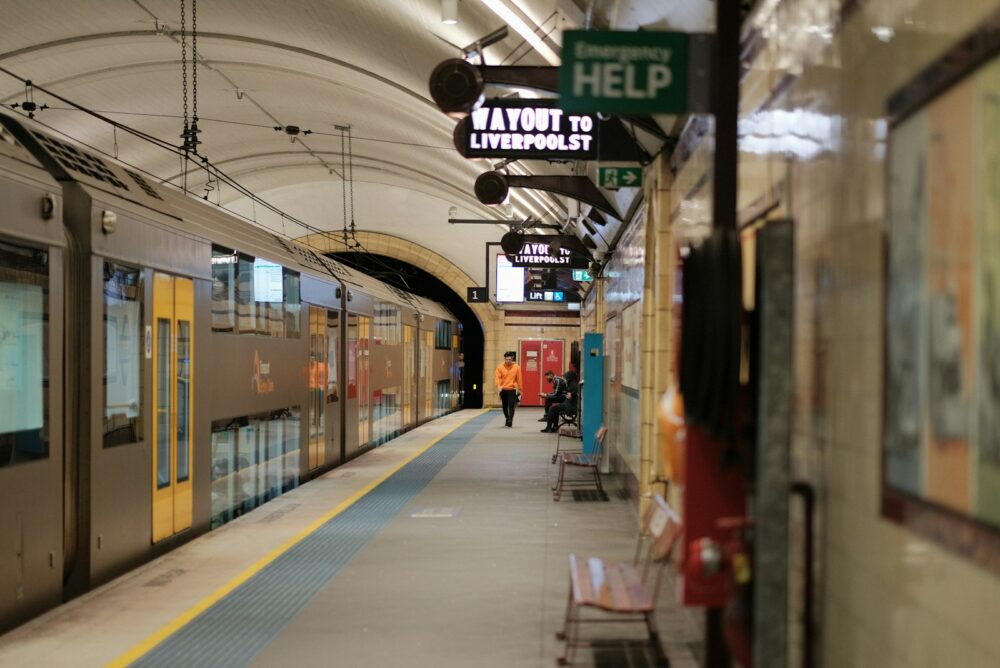 A train pulling into a train station next to a platform